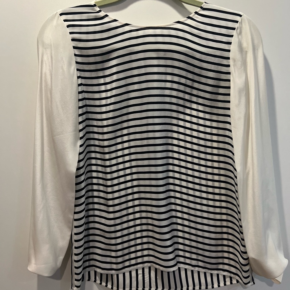 Brand new. Club Monaco. Tag still on. 100% silk blouse in xs.